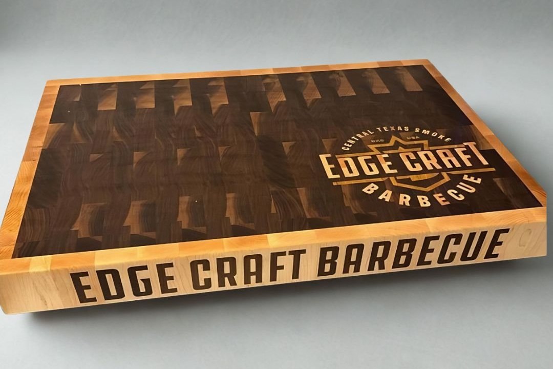Edge Craft Barbecue walnut end grain butcher block with a hard maple border, the logo inlaid in the top and the name inlaid along the side