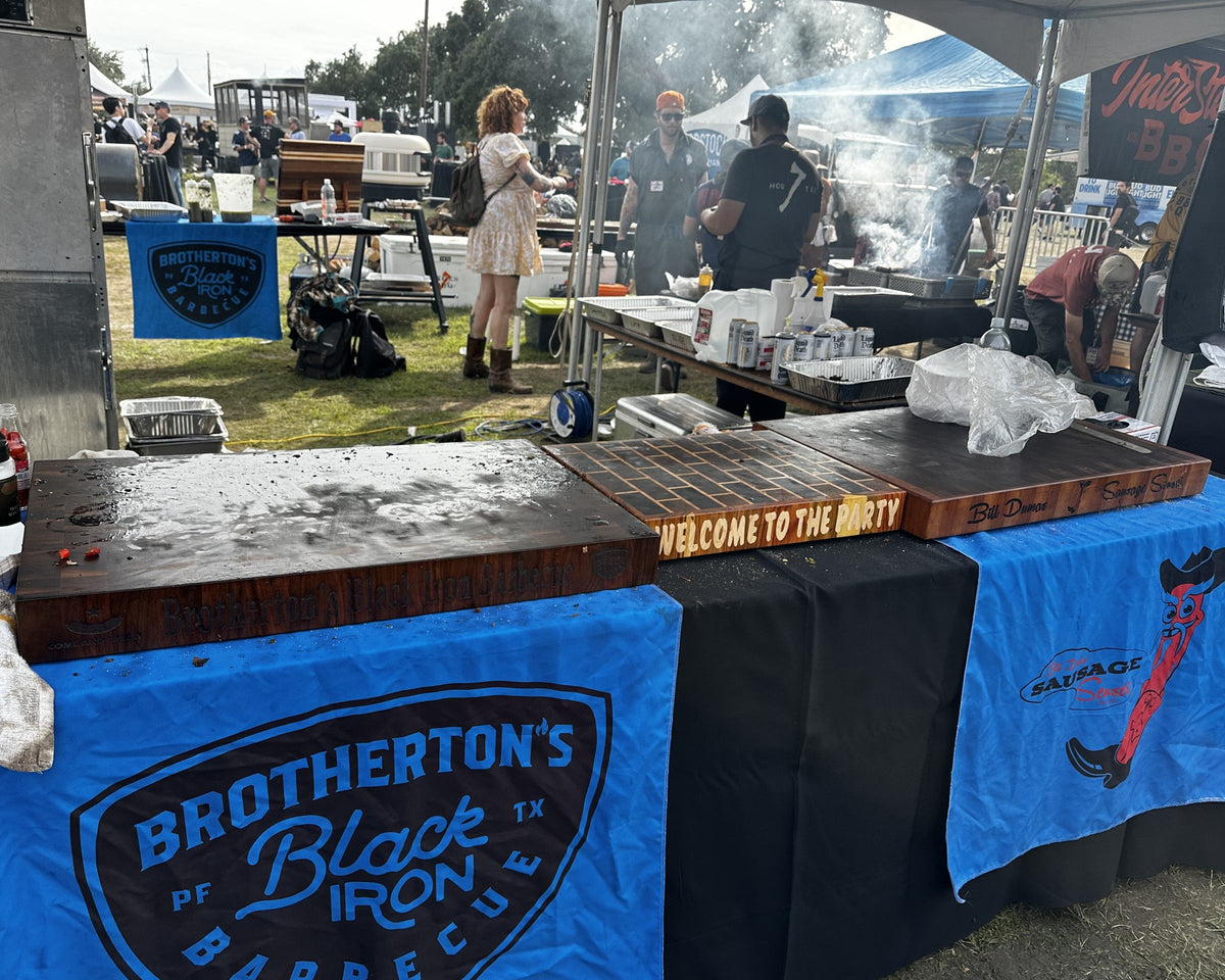 Brotherton's Black Iron Barbecue festival booth with end grain butcher blocks on the serving table